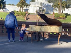 A child enjoying a piano outside the Conservatory of Flowers on JFK Drive in Golden Gate Park.