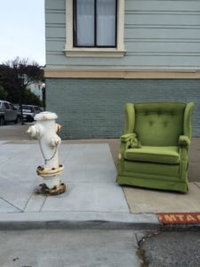Green chair next to a fire hydrant in San Francisco.