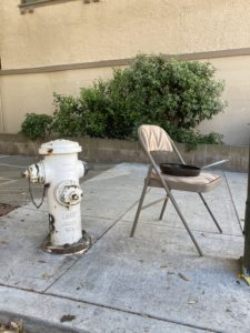 Chair and frying pan next to a fire hydrant in San Francisco.