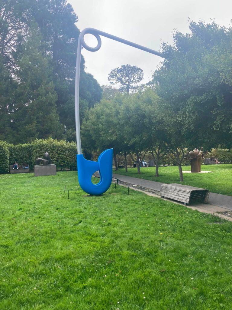 A large safety pin is part of the garden